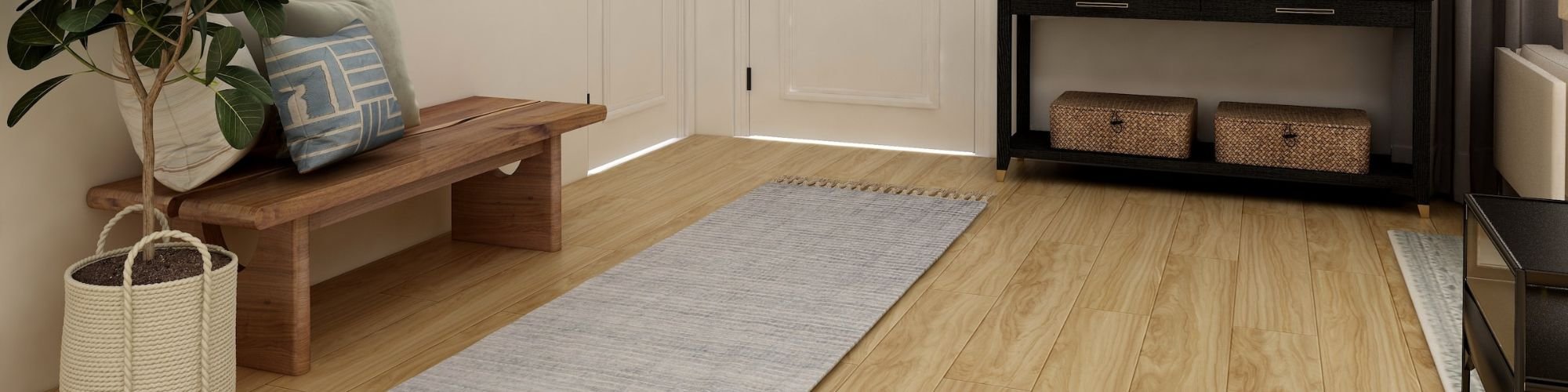 Golden wood-look flooring in a foyer with area rug and bench.